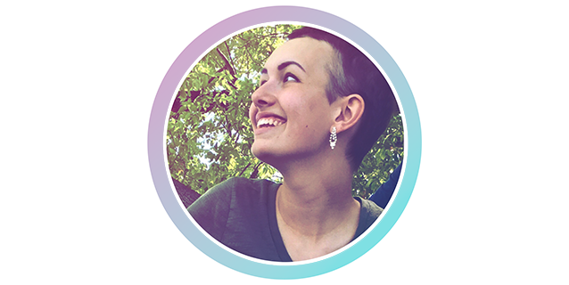 A photo of a woman smiling in front of a tree.