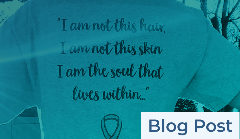 A woman wearing a t - shirt that says, i am not this hair, i am not the soul that lives within.