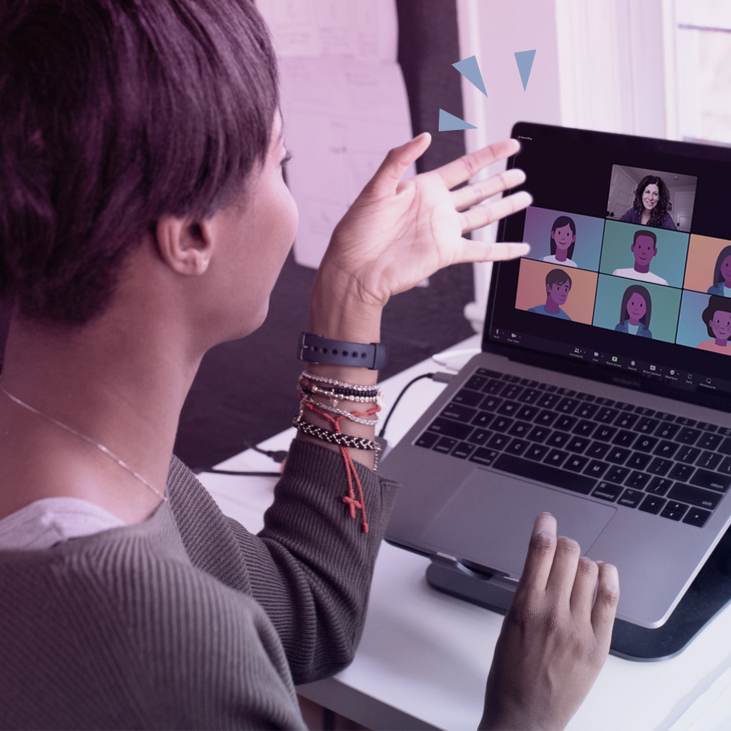 A woman is using a laptop with a group of people on it.