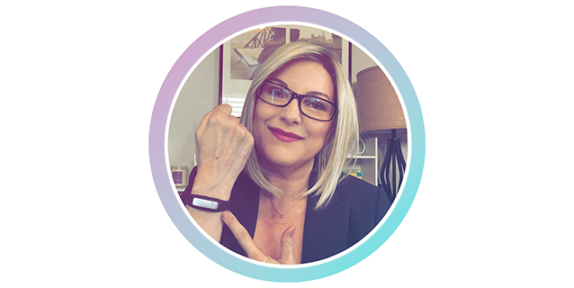 A woman in glasses is posing for a photo.