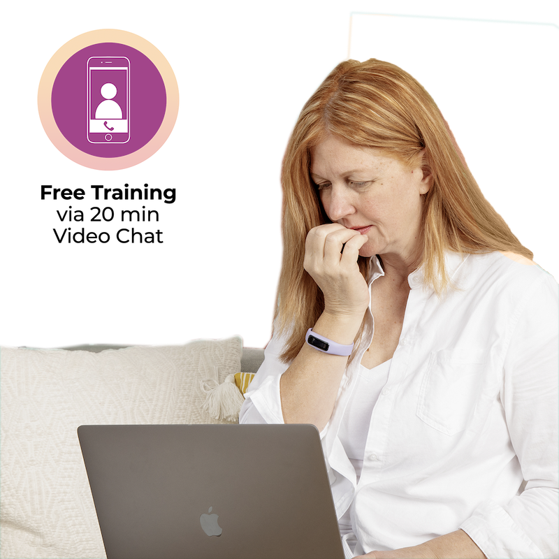A woman is sitting on a couch with a Sporty Keen - Black laptop in front of her.