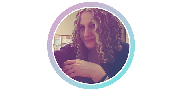 A photo of a woman with curly hair.