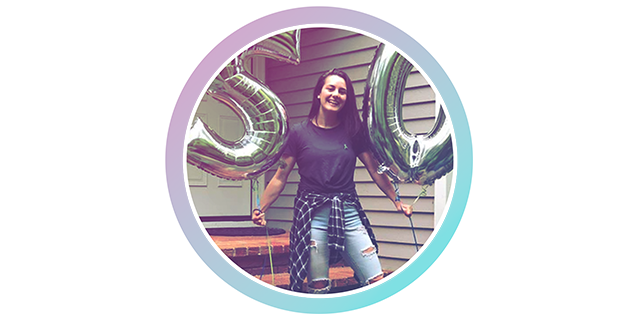 A photo of a woman holding balloons on her 50th birthday.