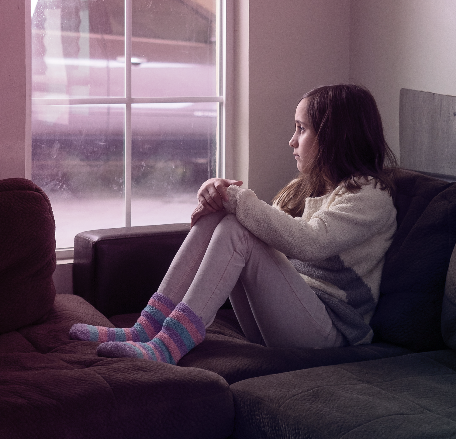 A girl sitting on a couch.