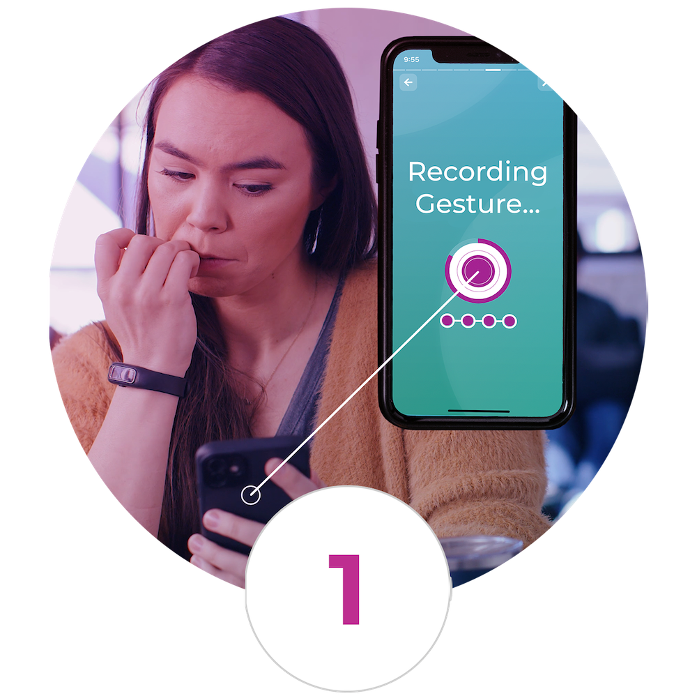 A woman is using her phone to record a gesture.