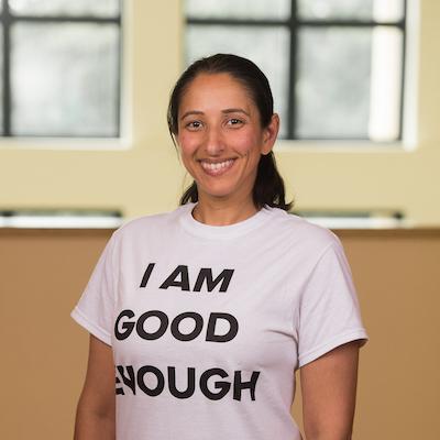 A woman wearing a t - shirt that says i am good enough.