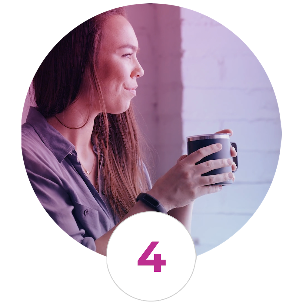 A woman is holding a cup of coffee in a circle.