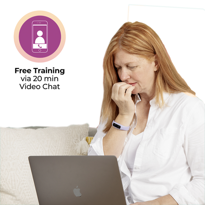 A woman is sitting on a couch with a Sporty Keen - Black laptop in front of her.