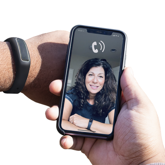 A person holding Virtual Peer BFRB Coaching with a woman's face on it.